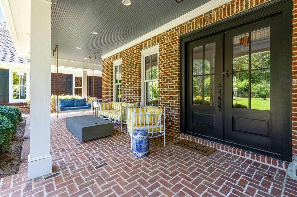 254 Nicholson Road Blue Ridge, GA 30513 - Photo 10 of 86 a view of a porch with a table and chairs