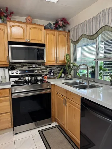 a kitchen with a sink stove and microwave