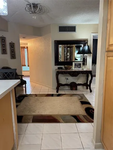 a living room with furniture a flat screen tv and a table