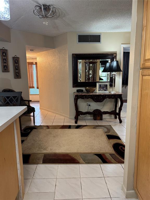 9400 Lime Bay Boulevard, Unit 112 Tamarac, FL 33321 - Photo 13 of 37 a living room with furniture a flat screen tv and a table