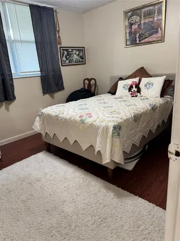 a bedroom with a bed and a wall painting