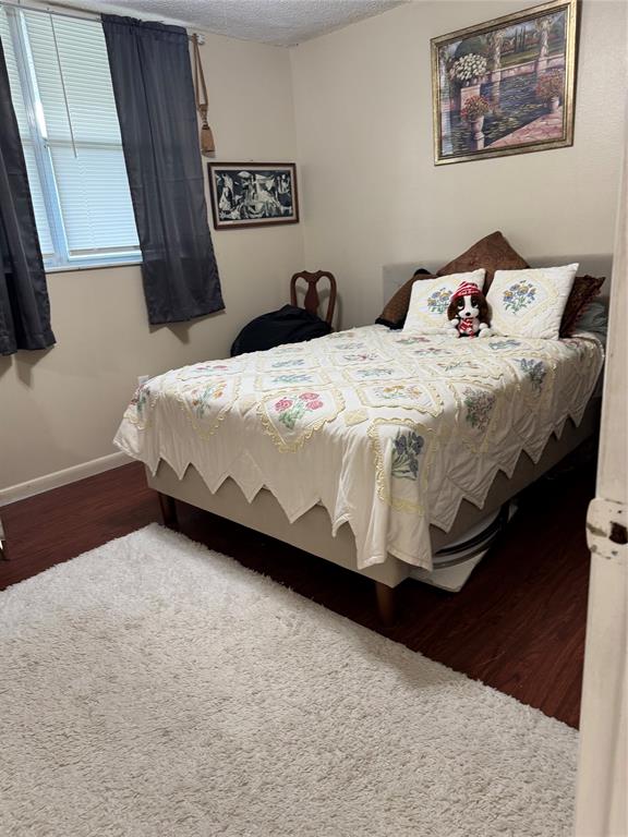 9400 Lime Bay Boulevard, Unit 112 Tamarac, FL 33321 - Photo 16 of 37 a bedroom with a bed and a wall painting