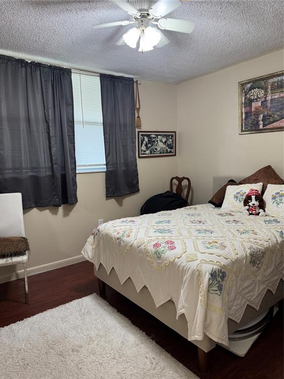 9400 Lime Bay Boulevard, Unit 112 Tamarac, FL 33321 - Photo 17 of 37 a bedroom with a bed and wooden floor