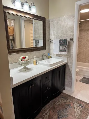 a bathroom with a sink vanity and a mirror