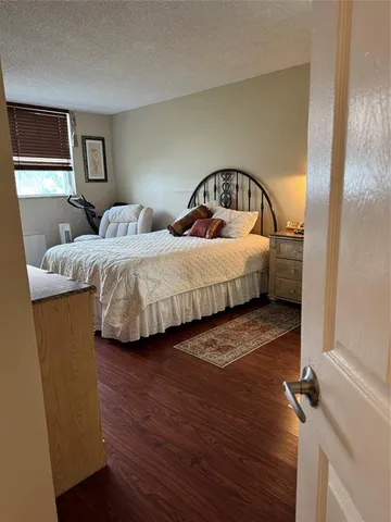 a bed room with a bed window and a flat screen tv