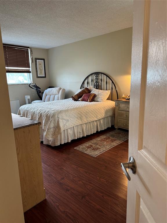 9400 Lime Bay Boulevard, Unit 112 Tamarac, FL 33321 - Photo 27 of 37 a bedroom with two beds and painting on the wall