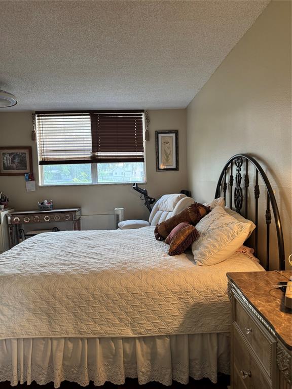 9400 Lime Bay Boulevard, Unit 112 Tamarac, FL 33321 - Photo 29 of 37 a bedroom with a bed and window