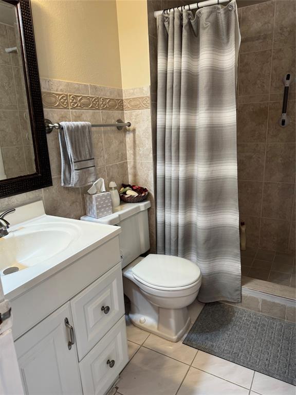 9400 Lime Bay Boulevard, Unit 112 Tamarac, FL 33321 - Photo 31 of 37 a bathroom with a sink toilet and shower