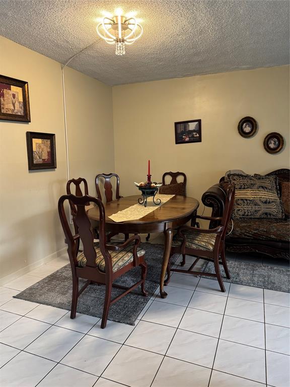 9400 Lime Bay Boulevard, Unit 112 Tamarac, FL 33321 - Photo 6 of 37 a view of a dining room with furniture and chandelier