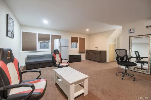a living room with furniture a air conditioner and a window