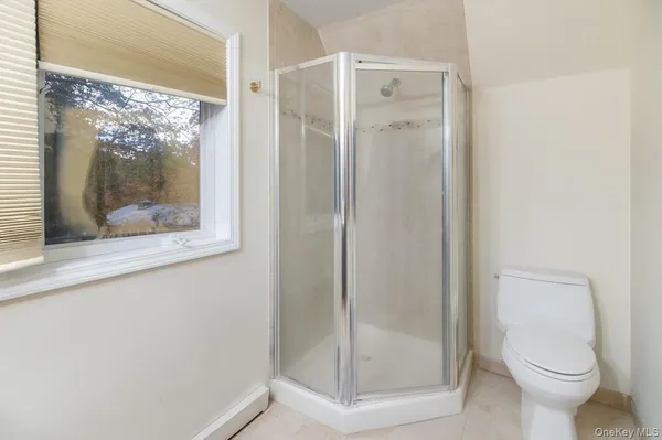 a bathroom with a glass shower door