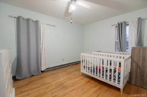 a view of a bedroom with wooden floor