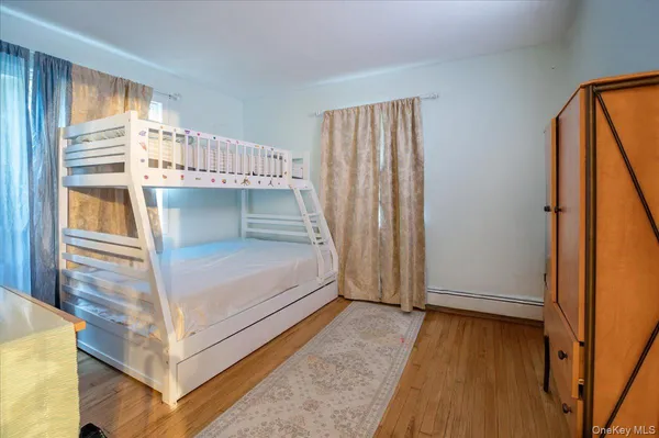 a view of a room with wooden floor and windows