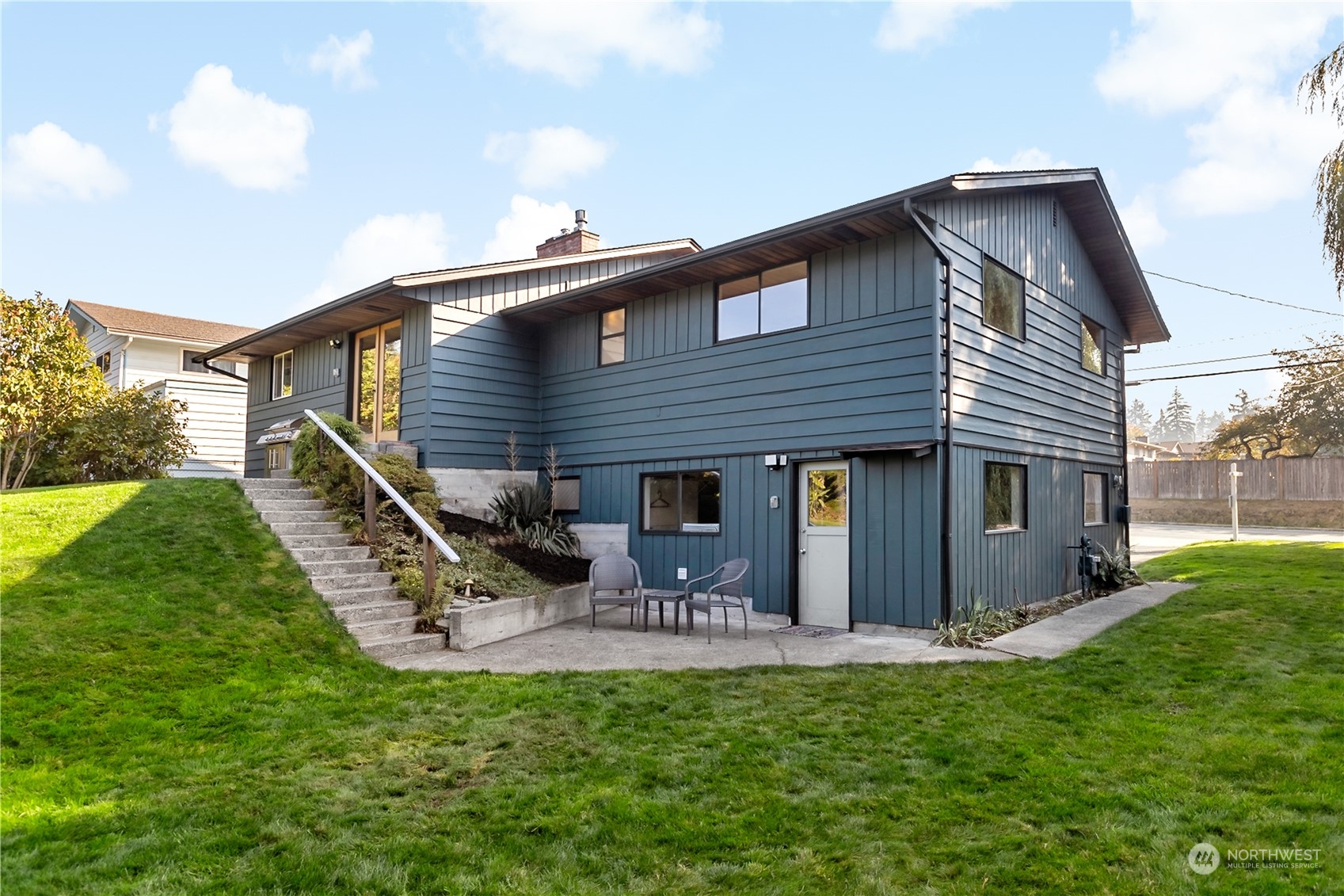 a front view of house with a garden