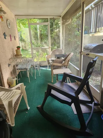 a view of a porch with chairs and backyard