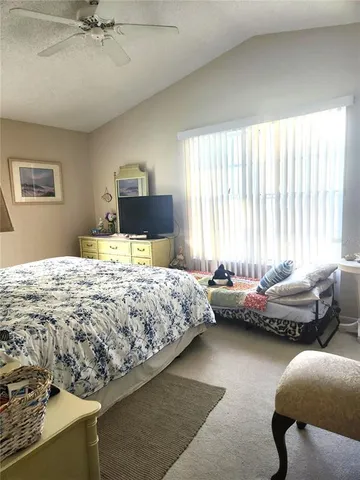 a bedroom with a bed and window