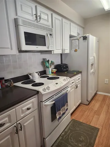 a kitchen with a stove microwave and refrigerator