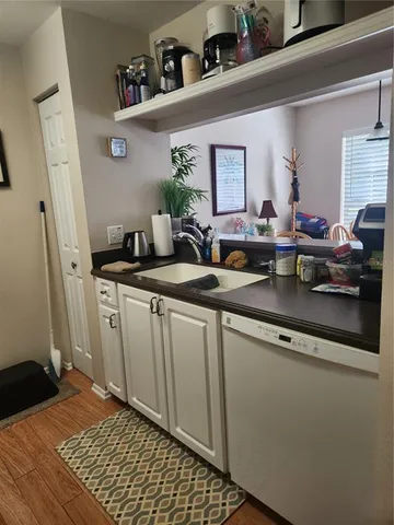 a kitchen with sink and cabinets
