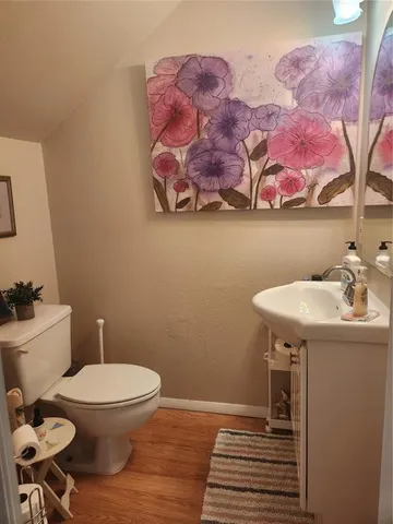 a bathroom with a toilet sink and mirror