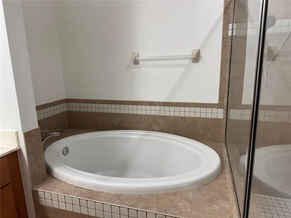 a bathroom with a bathtub and a shower