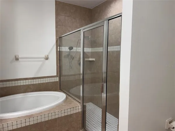 a bathroom with a tub a sink and mirror