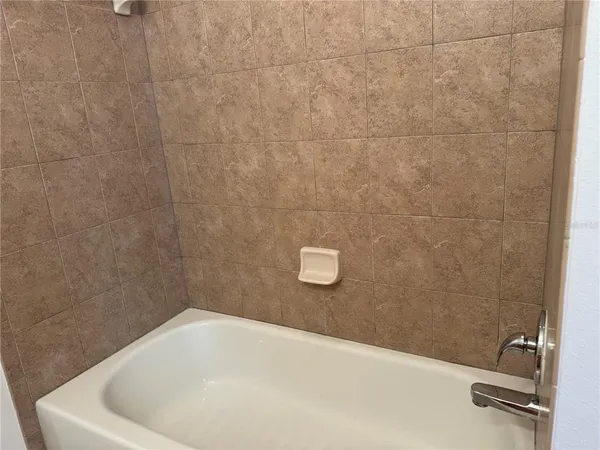 a bathroom with a toilet and bathtub