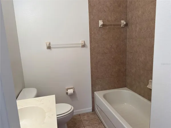 a view of a patio with table and chairs with wooden fence and plants