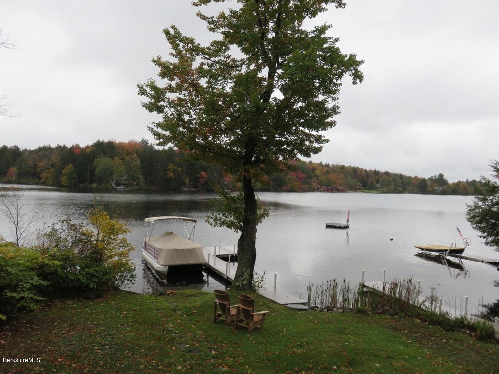 249 Old Pond Road Becket, MA 01223 - Photo 1 of 20 a view of a lake with a yard and trees