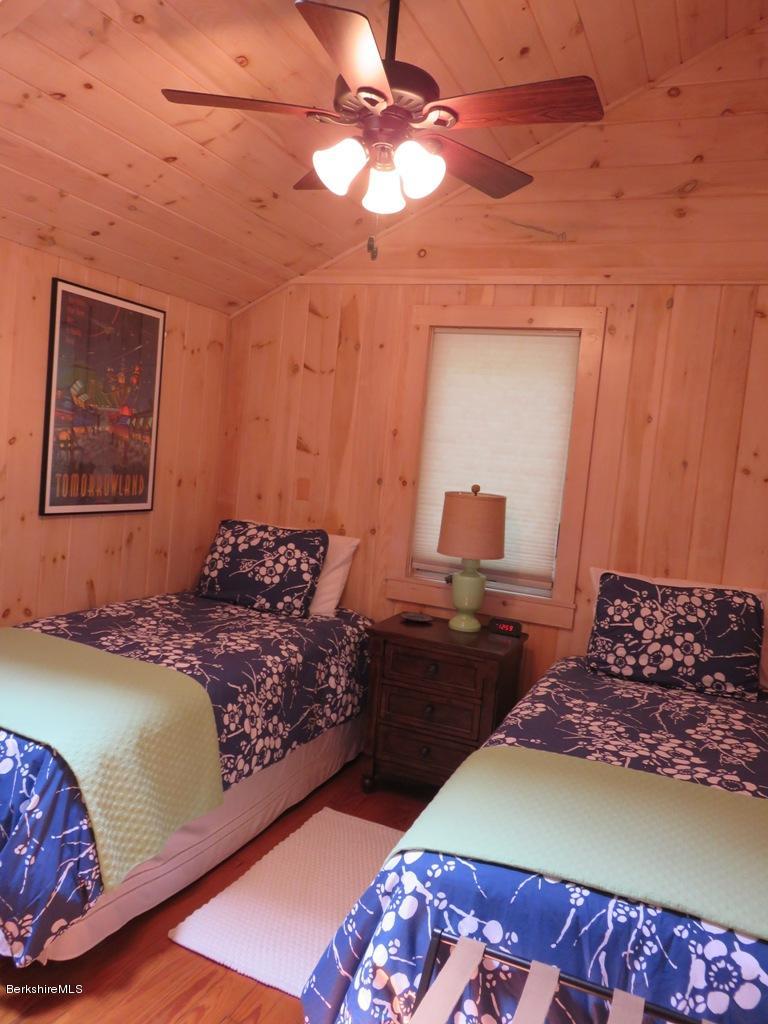 249 Old Pond Road Becket, MA 01223 - Photo 14 of 20 a bedroom with a bed and a lamp with the rug