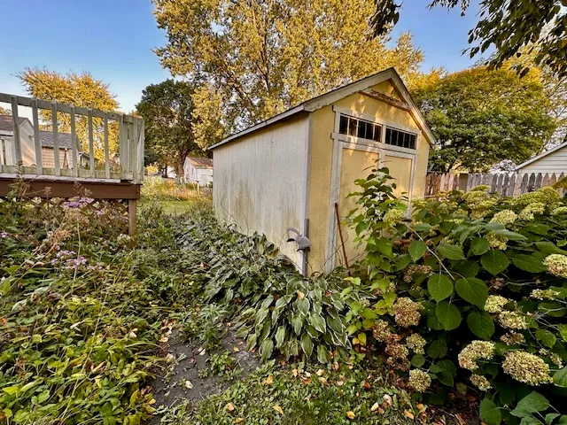 a backyard of a house with lots of flowers and trees
