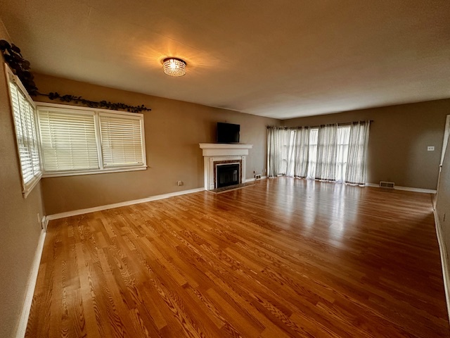 403 16th Street Mendota, IL 61342 - Photo 4 of 17 a view of an empty room with wooden floor and a window