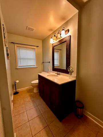 a bathroom with a sink vanity and mirror