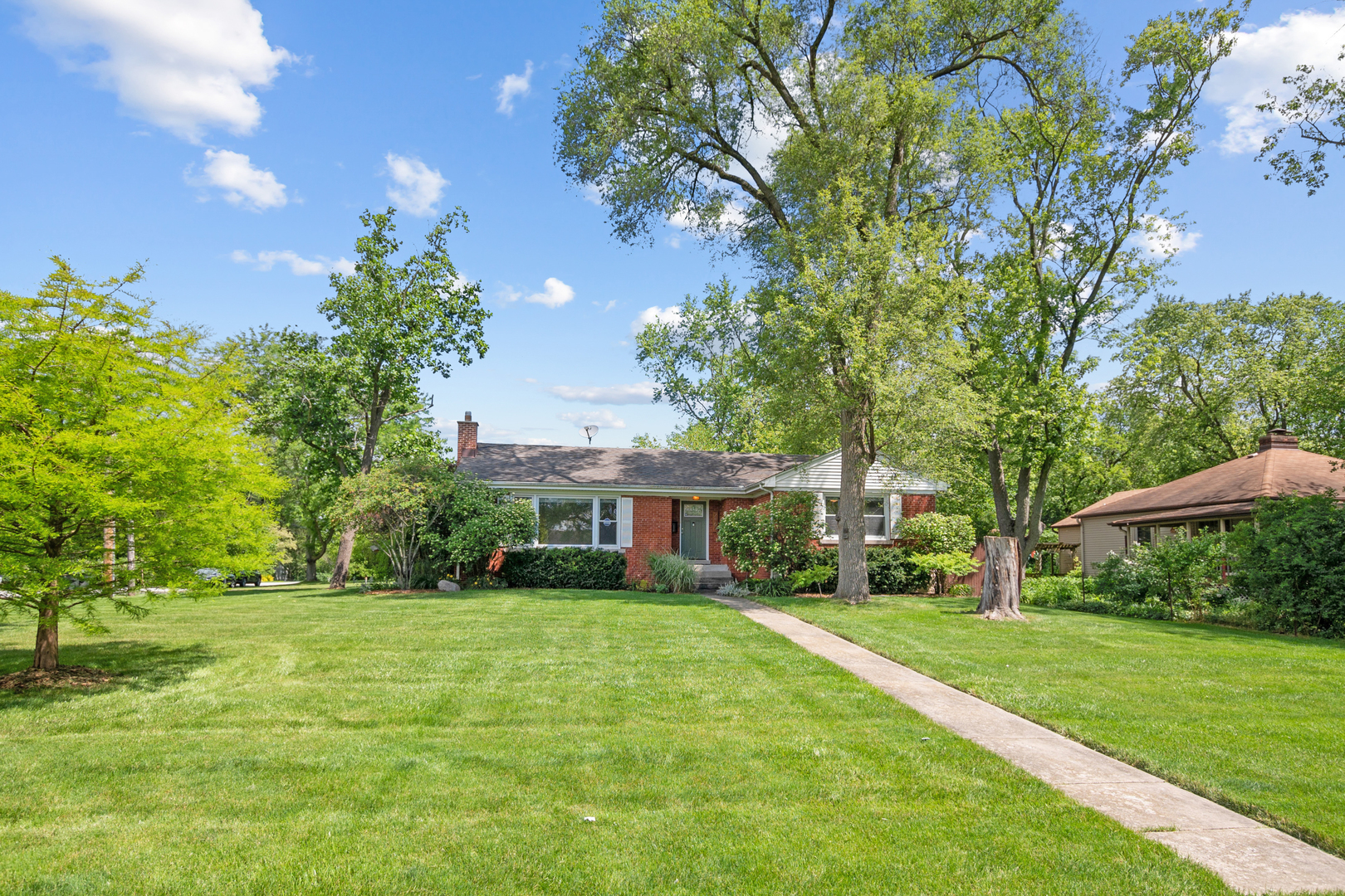 a house view with swimming pool and garden