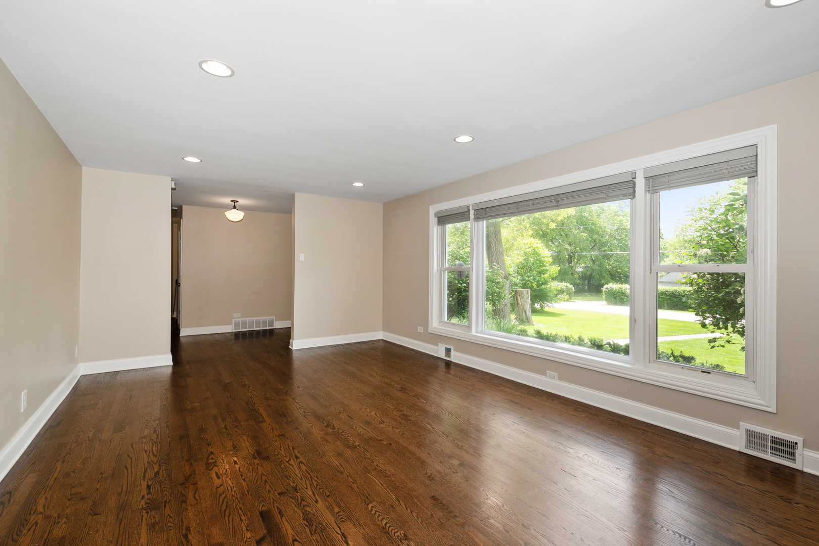 2860 Birch Road Homewood, IL 60430 - Photo 3 of 24 a view of an empty room with wooden floor and a window