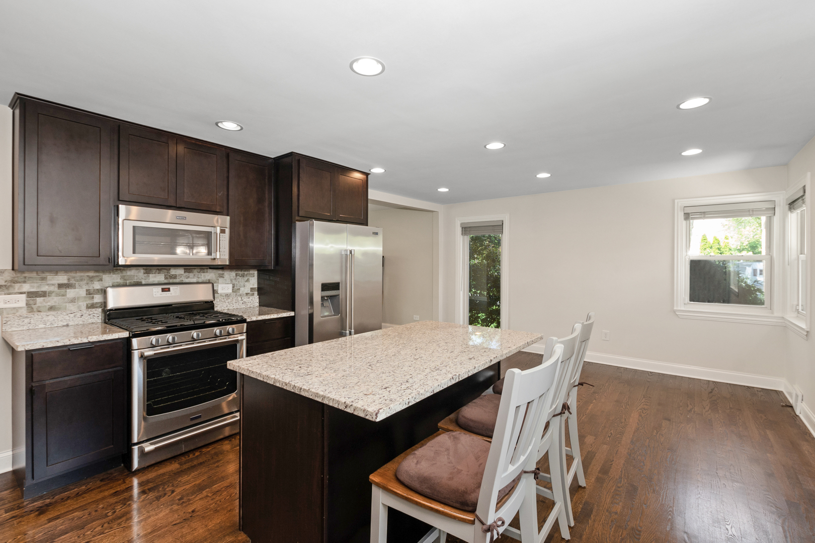 2860 Birch Road Homewood, IL 60430 - Photo 6 of 24 a kitchen with a table chairs refrigerator and microwave