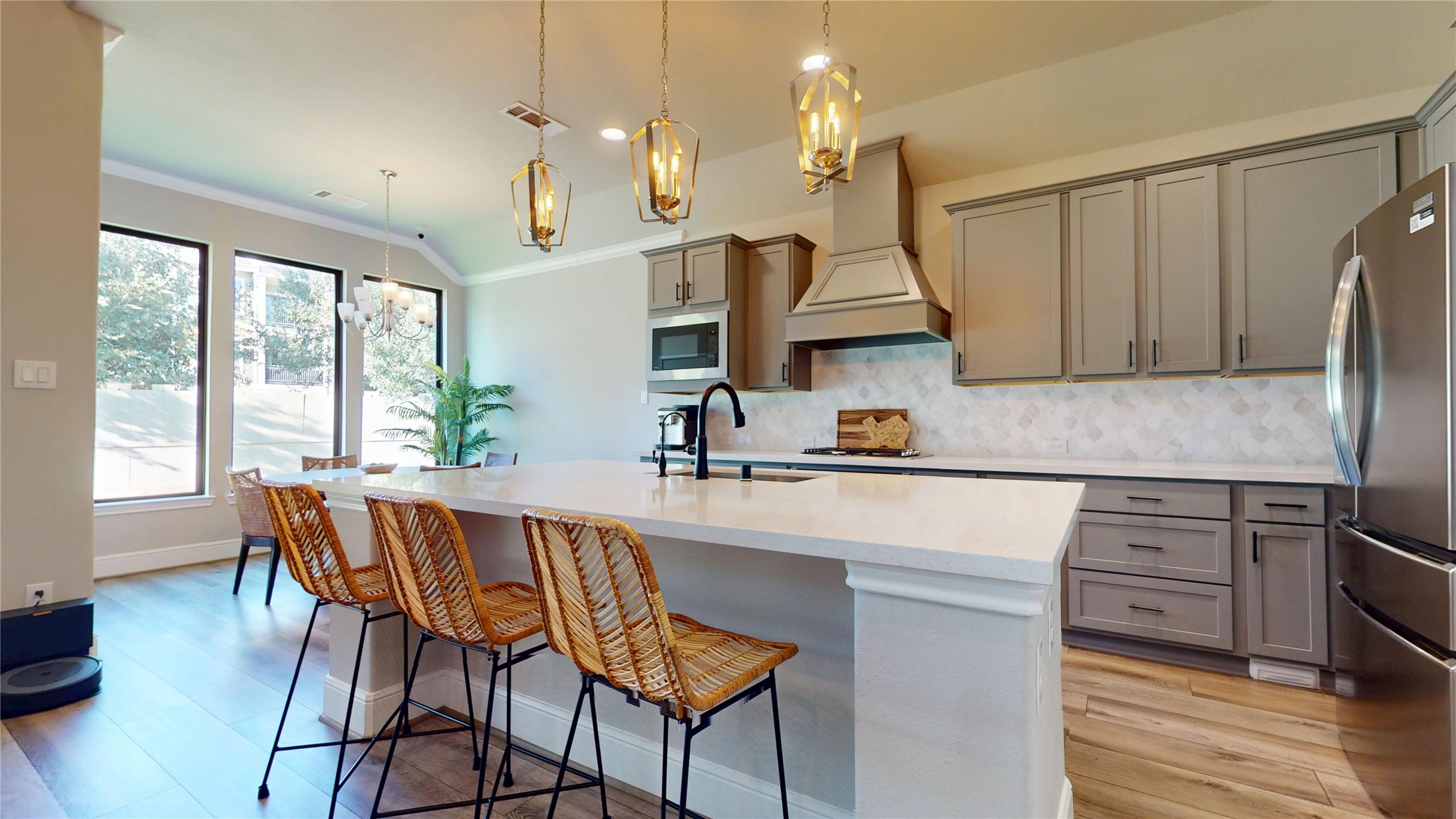8305 Greenleaf Ridge Way Conroe, TX 77385 - Photo 8 of 33 a kitchen with a table chairs stove and cabinets