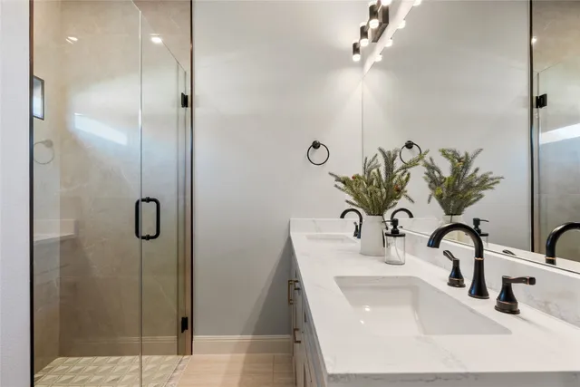 a bathroom with a sink a mirror and shower