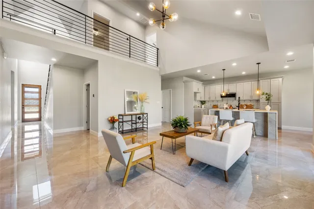 a living room with furniture and kitchen view