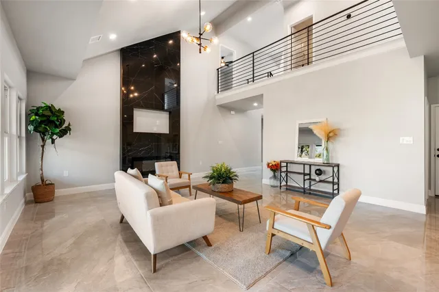 a living room with furniture and a potted plant