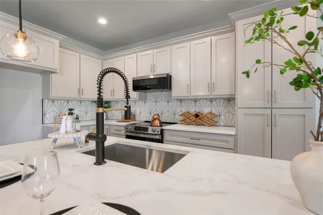 a kitchen with a refrigerator and a stove top oven