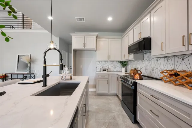 a kitchen with a sink and stove