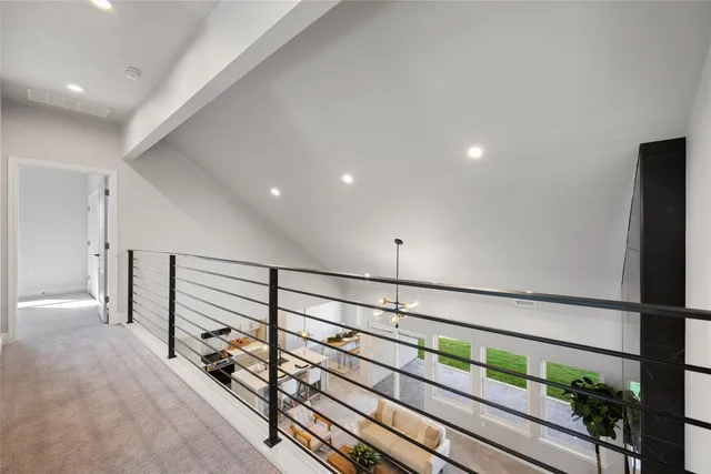 a view of a hallway with entryway and stairs