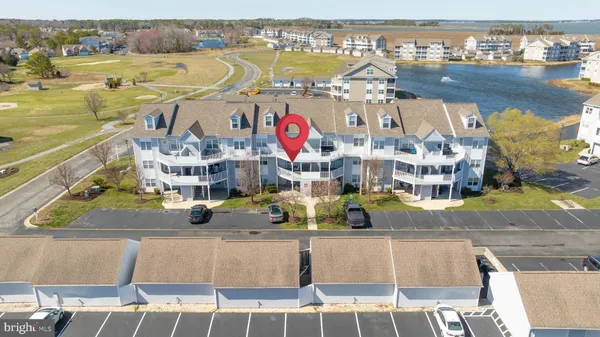 a view of a chair and table in the back yard of the house