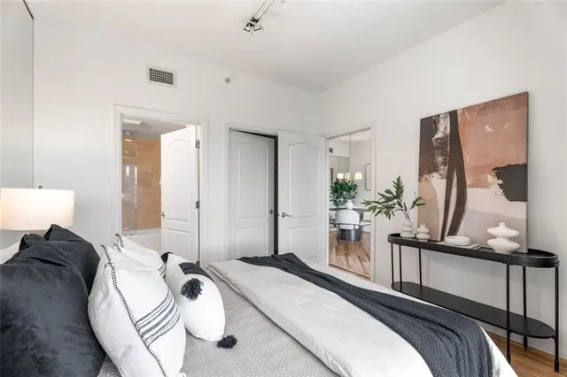 a bedroom with a bed and a large mirror