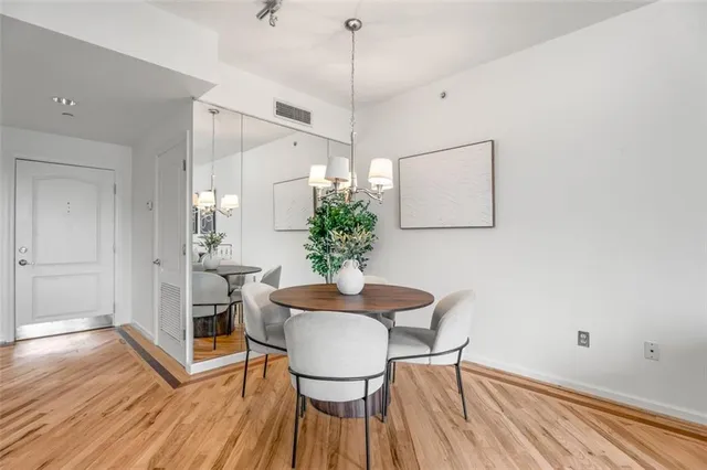 a view of a dining room with furniture and wooden floor