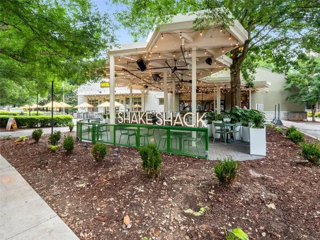 a view of a house with a yard and potted plants
