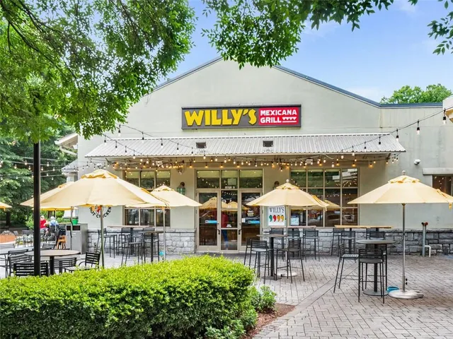 an outdoor space with tables and chairs