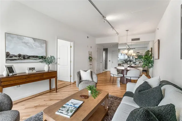 a living room with furniture and a painting on the wall