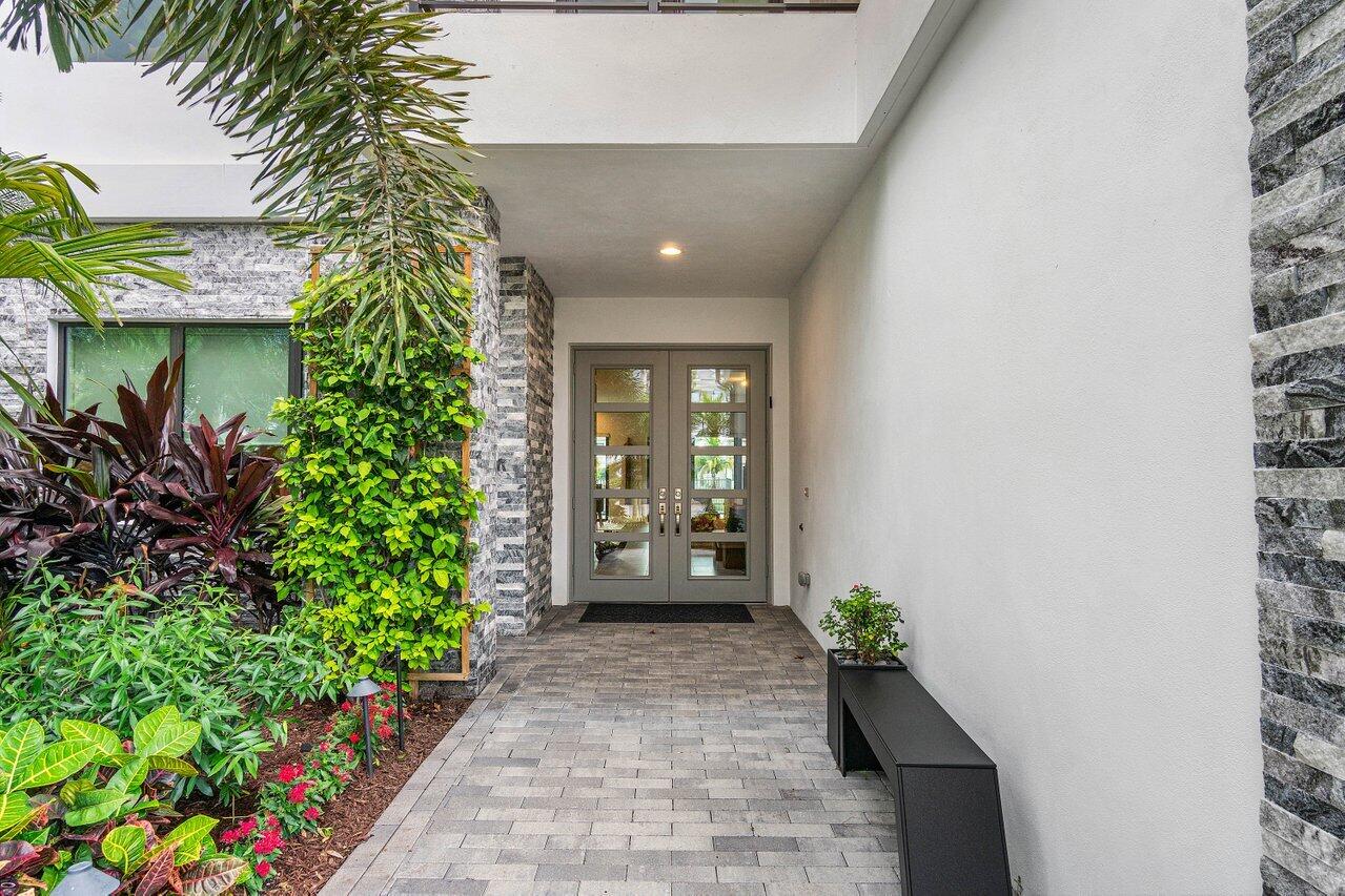 8581 Dearborn River Way Boca Raton, FL 33496 - Photo 2 of 53 a view of a entryway door with potted plants