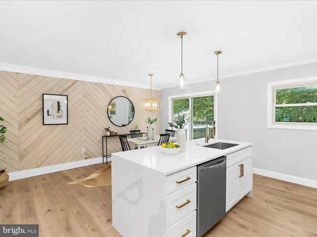 a view of a kitchen with a sink a window and a wooden floor